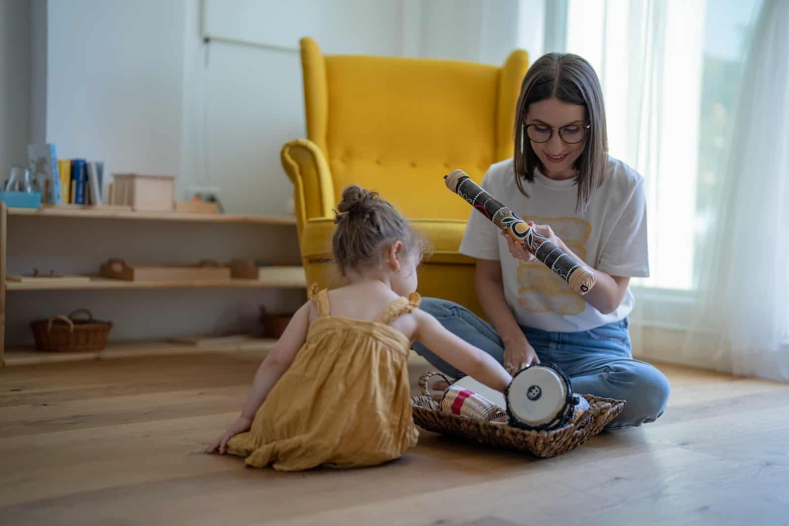 a person and a child sitting on a yellow chair