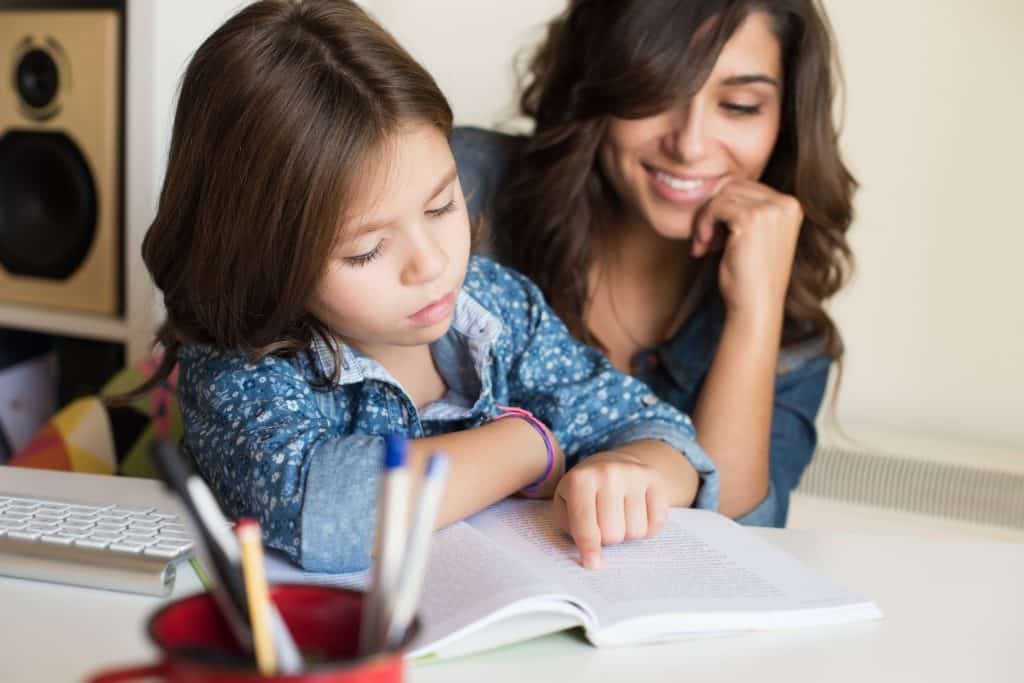 Mother helping child with speech therapy