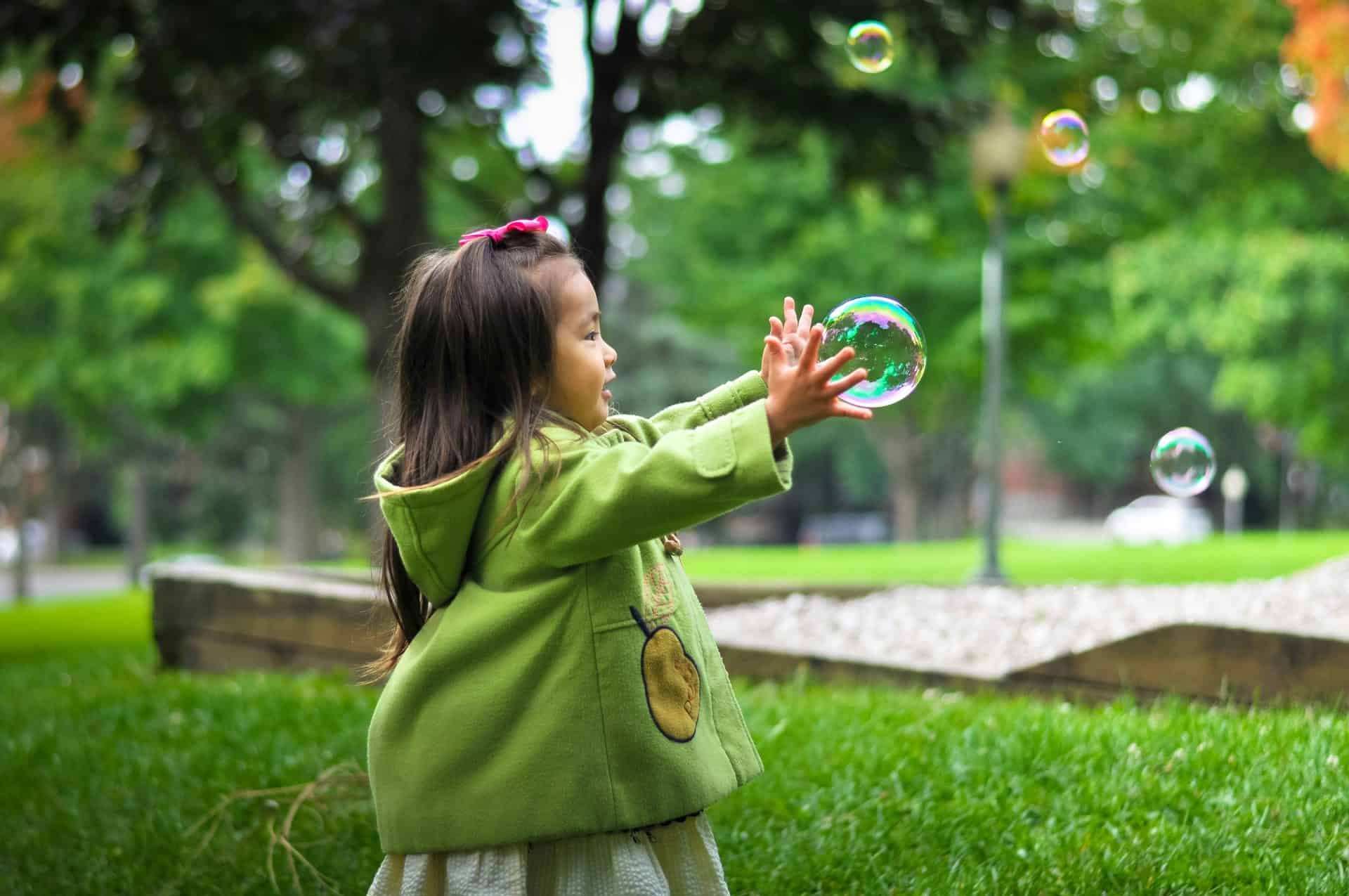 Child reaching for bubble